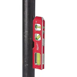 Milwaukee torpedo level with red aluminum body and three bubble vials attached magnetically to a metal pipe.