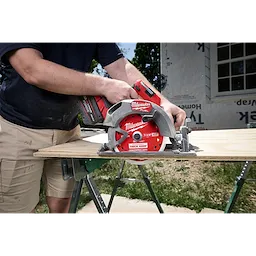 7-1/4" 40T Thick Kerf Finish Circular Saw Blade mounted on a cordless saw cutting plywood on sawhorses.