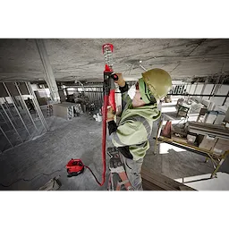 Worker on ladder using SDS+ DUST TRAP Drilling Shroud Bulk 10 to drill into a concrete ceiling on a construction site.