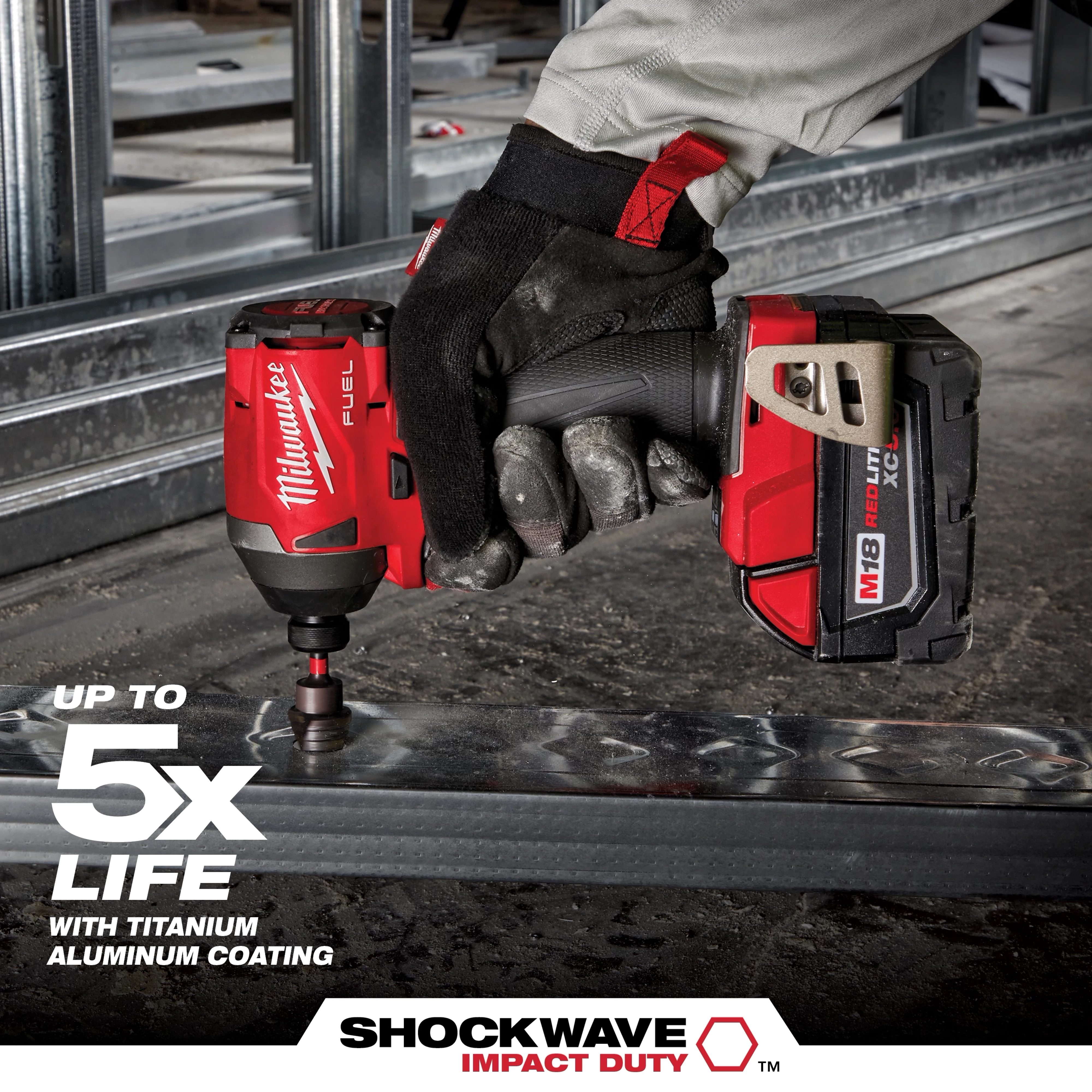 A gloved hand holds a red cordless drill fitted with a SHOCKWAVE Step Bit, working on the edge of a metal frame. Text on the image highlights up to five times longer life, with titanium aluminum coating. The drill brand name and logos are visible in red and white.