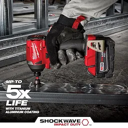 A gloved hand holds a red cordless drill fitted with a SHOCKWAVE Step Bit, working on the edge of a metal frame. Text on the image highlights up to five times longer life, with titanium aluminum coating. The drill brand name and logos are visible in red and white.