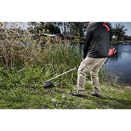 Worker using the M18 FUEL QUIK-LOK Brush Cutter Attachment