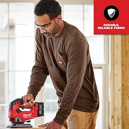 GRIDIRON Pocket T-Shirt - Long Sleeve, made from durable, reliable fabric, being worn by a person using a red power tool.