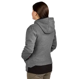 A woman is wearing a gray M12™ Women's Heated Hoodie with a hood. The back view highlights the hoodie’s fabric texture and design. The hoodie ends above her khaki pants.