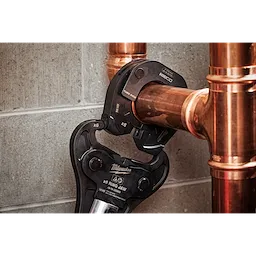 3" NIBCO Press Ring connected to an M18 FORCE LOGIC Long Throw Press Tool, securing copper pipes against a concrete wall.