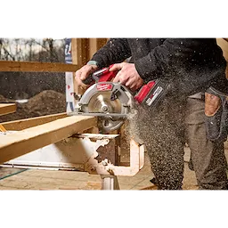 Image of a worker using the Milwaukee M18 FUEL 6-1/2" Circular Saw on a jobsite to cut wood