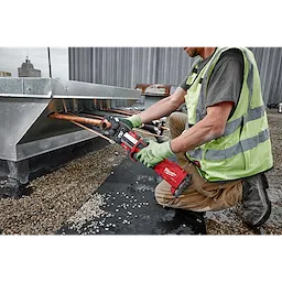 Worker using M18 FORCE LOGIC Press Tool Kit with One-Key and 1/4"-7/8" Streamline ACR Jaws on copper pipes on a rooftop.