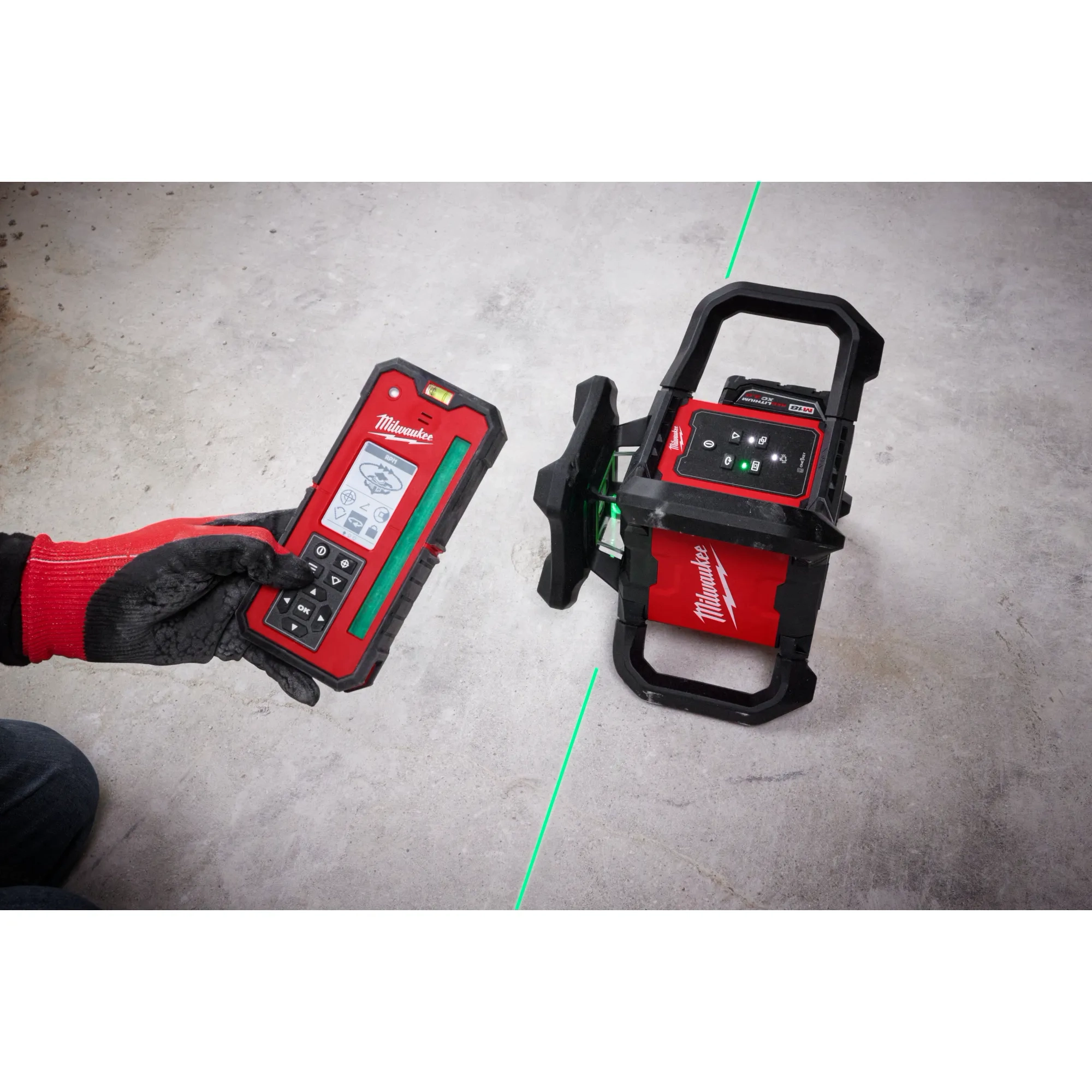 Image of the Milwaukee M18 Green Interior Rotary Laser Level Kit w/ Remote/Receiver & Wall Mount Bracket being used by a worker on a jobsite floor