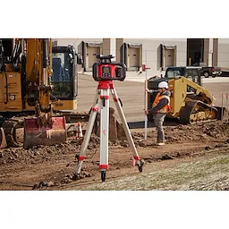 The Red Exterior Rotary Laser Level on the tripod that is placed on top of dirt
