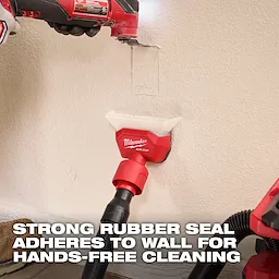 AIR-TIP Compact Dust Collector attached to a vacuum hose, adhering to a wall for hands-free cleaning with a rubber seal.