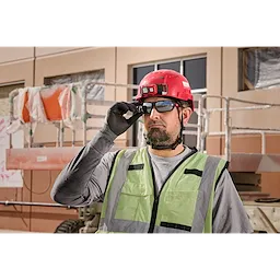 Construction worker wearing Mirrored Performance Safety Glasses - Fog-Free Lenses, a red hard hat, and a reflective vest.