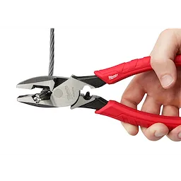 9" High Leverage Lineman's Pliers with Crimper held by a hand, cutting through a thick wire, with red handles.