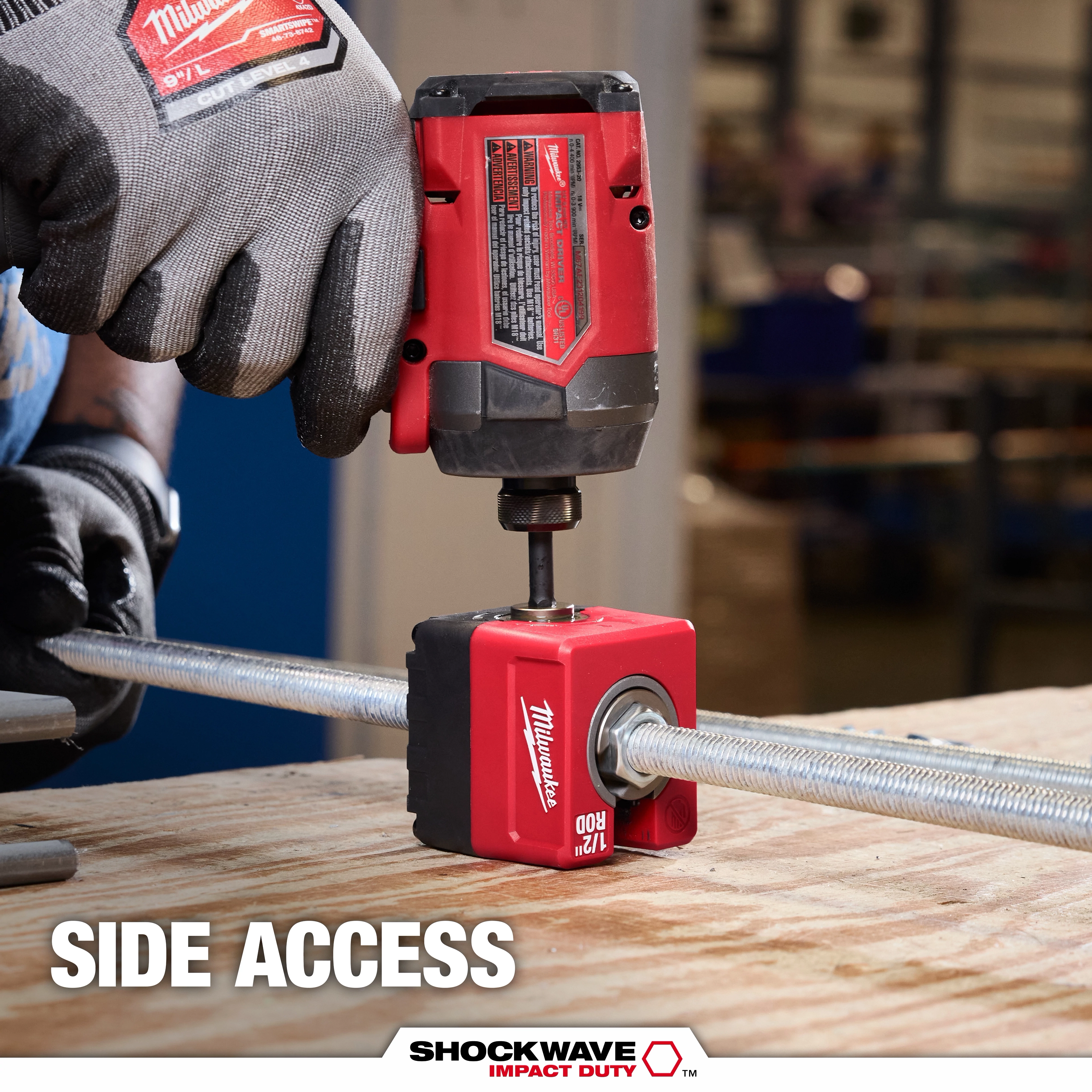 SHOCKWAVE Impact Duty 1/2" Threaded Rod Nut Runner clamped on a threaded rod on a workbench in a workshop.
