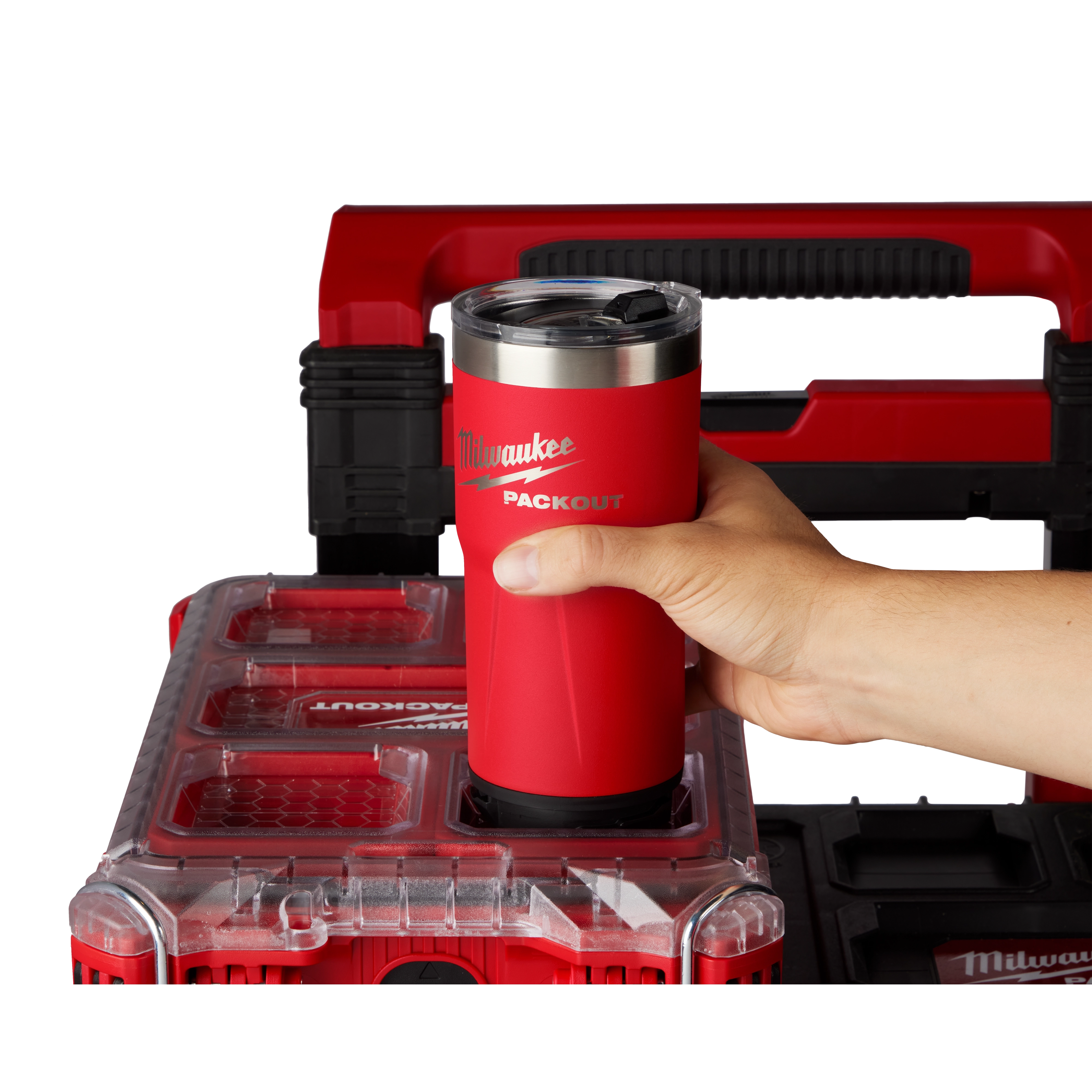 User putting the PACKOUT Tumbler in the PACKOUT cup holder