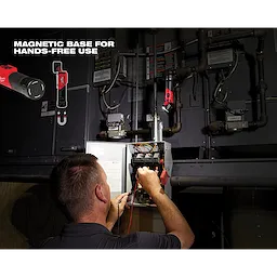 Person uses REDLITHIUM USB Pivoting Flashlight with a magnetic base, working hands-free on an open electrical panel in a dimly lit room.