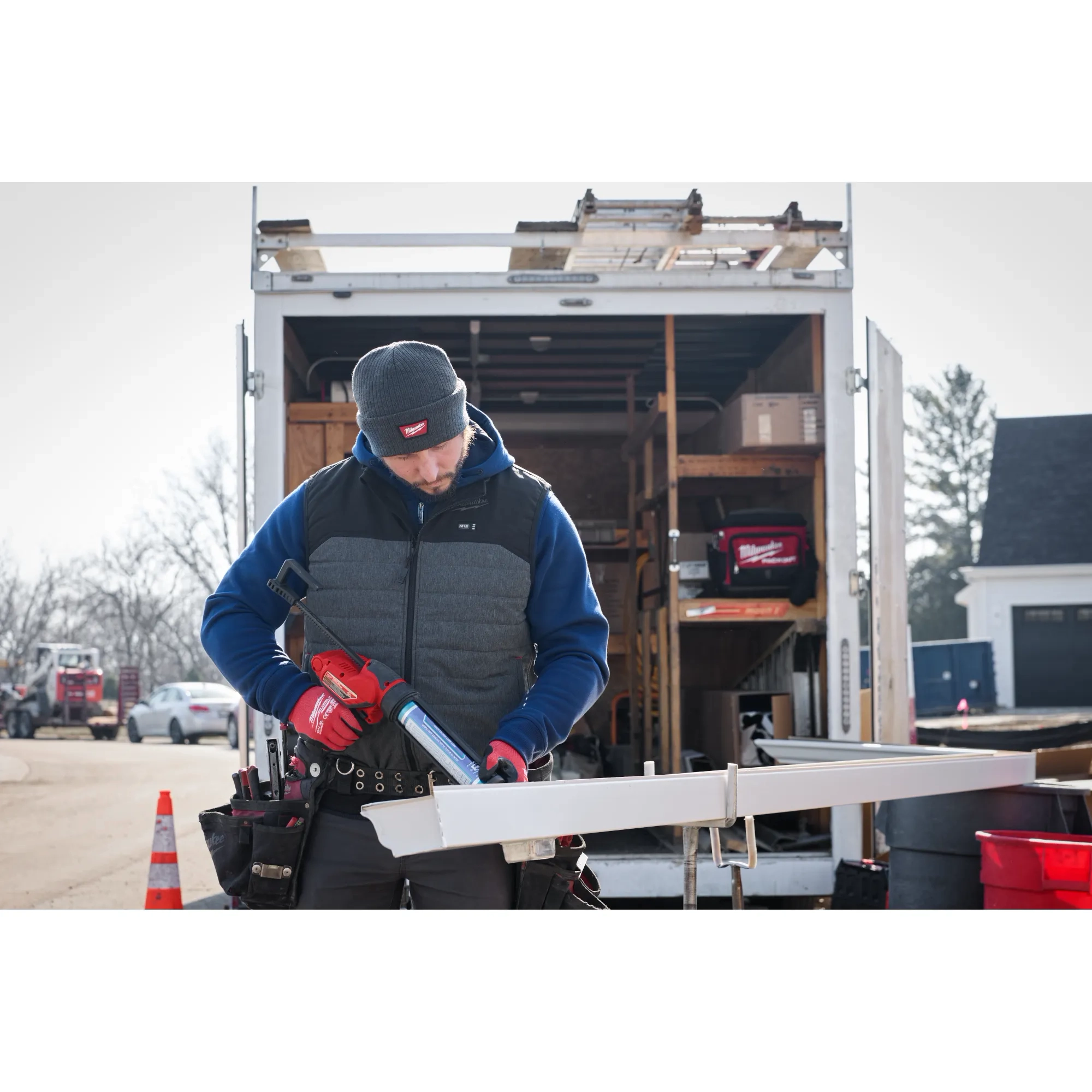 Image of a man on a jobsite wearing the Milwaukee Rib-Knit Cuffed Beanie in gray