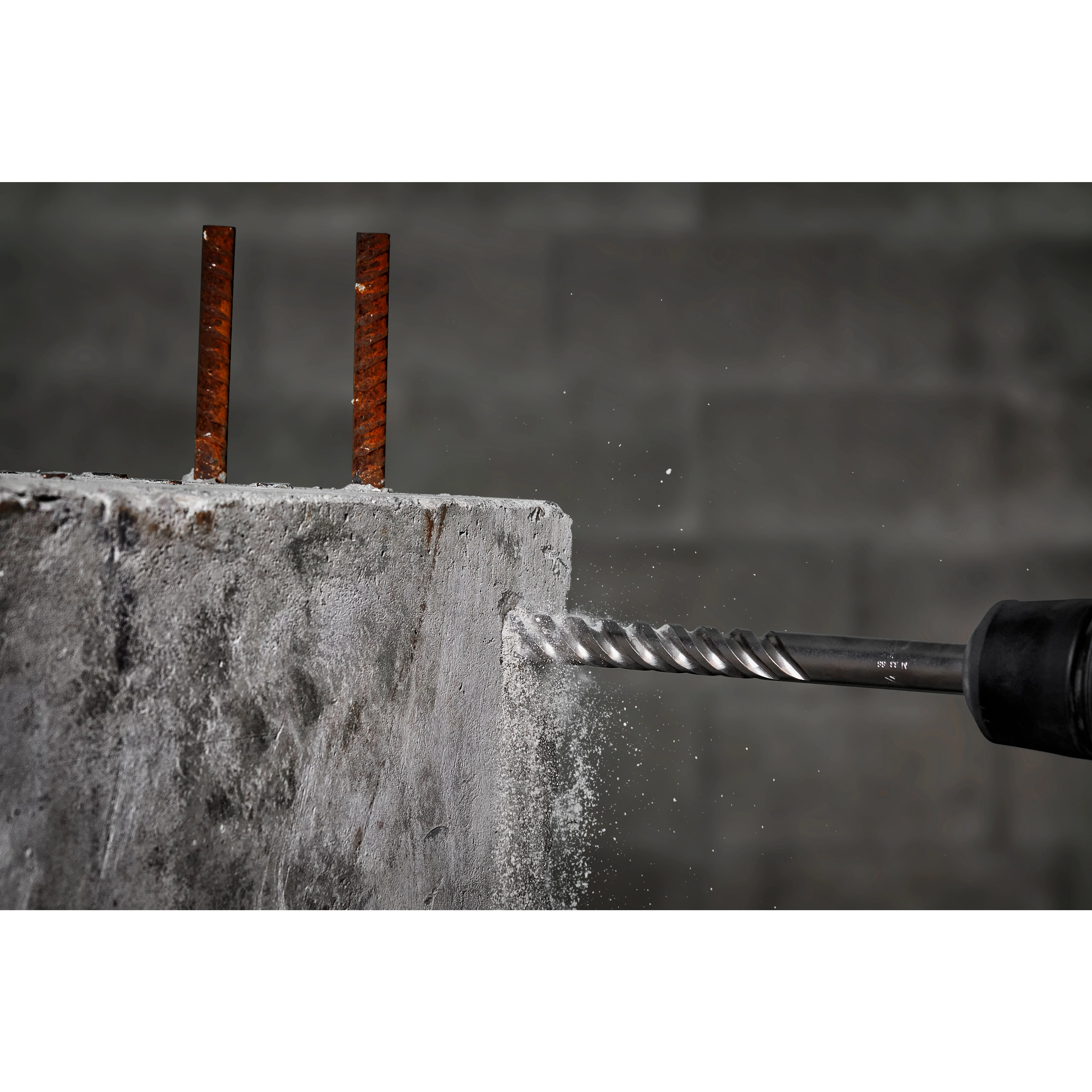 The MILWAUKEE® MX4™ 4-Cutter SDS MAX Rotary Hammer Drill Bits 3/4" X 8" X 13" drilling into a concrete wall