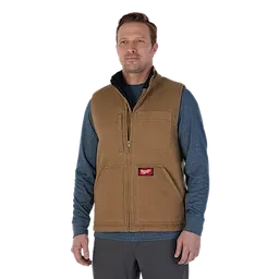 Man wearing the brown heavy duty sherpa-lined vest over the blue pullover hoodie