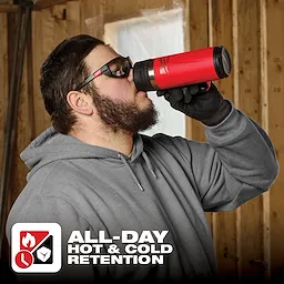 Man in work attire drinking from PACKOUT 18oz Insulated Mug with Sip Lid, designed for hot and cold retention all day.