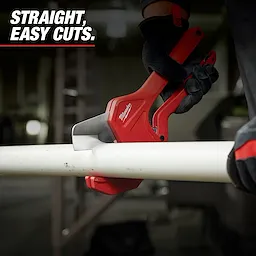 Person cuts a white PVC pipe using Milwaukee Pipe Cutters. The tool has a red handle and black grip, ensuring precise and easy cuts. The background features a workshop setting and the text "STRAIGHT, EASY CUTS" is displayed at the top left.