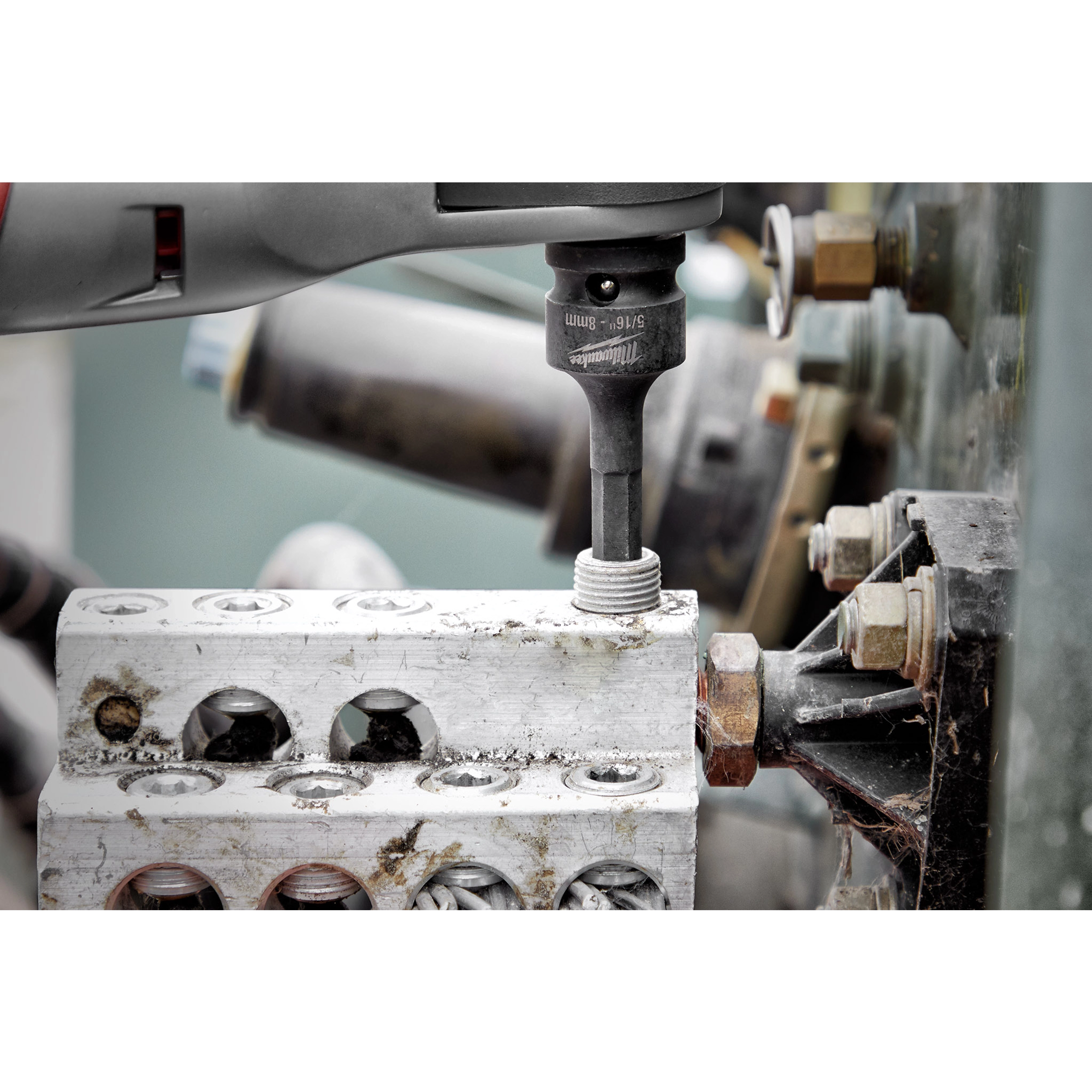Shockwave Lineman's 6PT 9/16" x 3/4" 2-in-1 Socket attached to a power tool, screwing a bolt into an electrical terminal block.