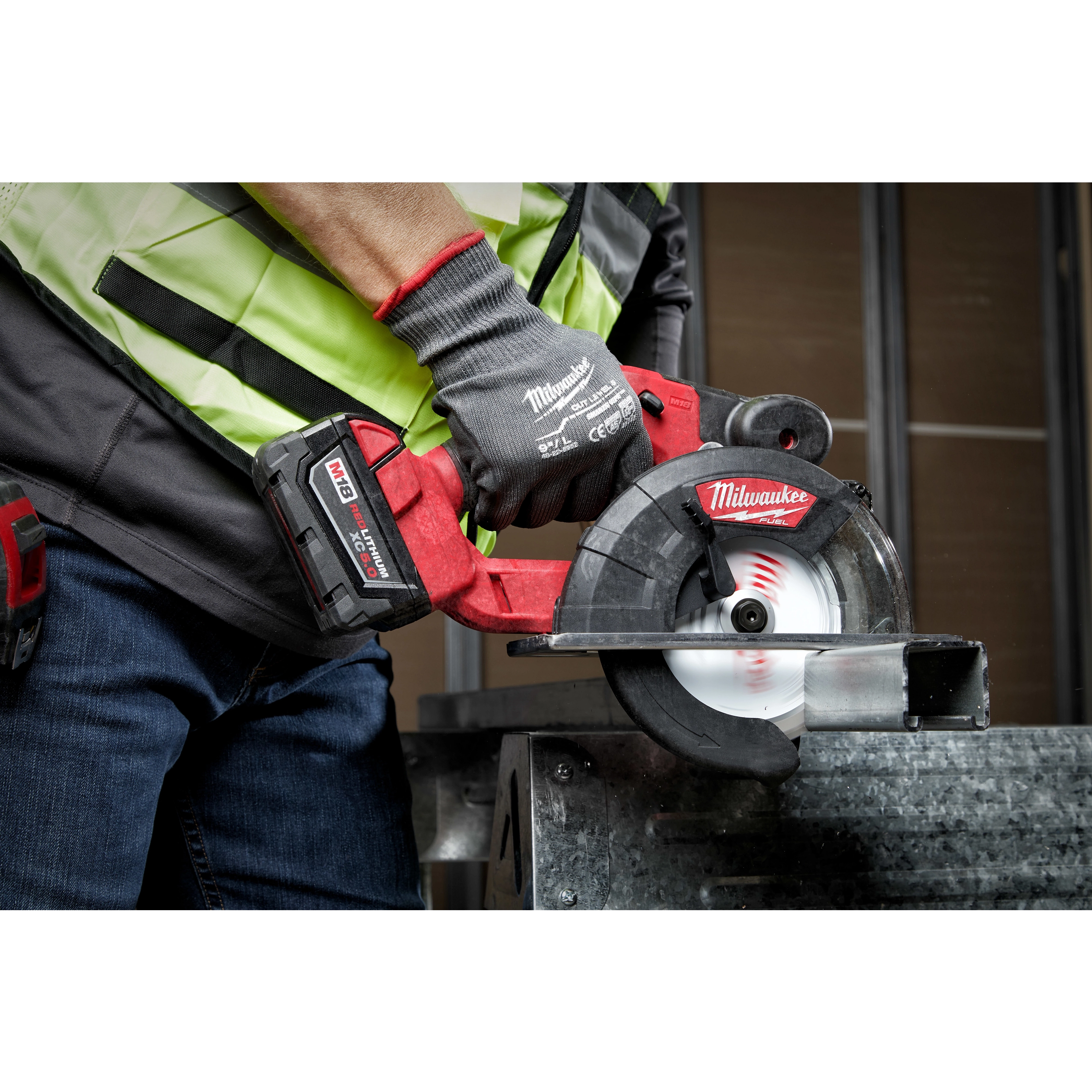 Person using a cordless circular saw with a 5-3/8" 30T metal cutting circular saw blade, cutting through a metal piece.