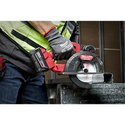 Person using a cordless circular saw with a 5-3/8" 30T metal cutting circular saw blade, cutting through a metal piece.