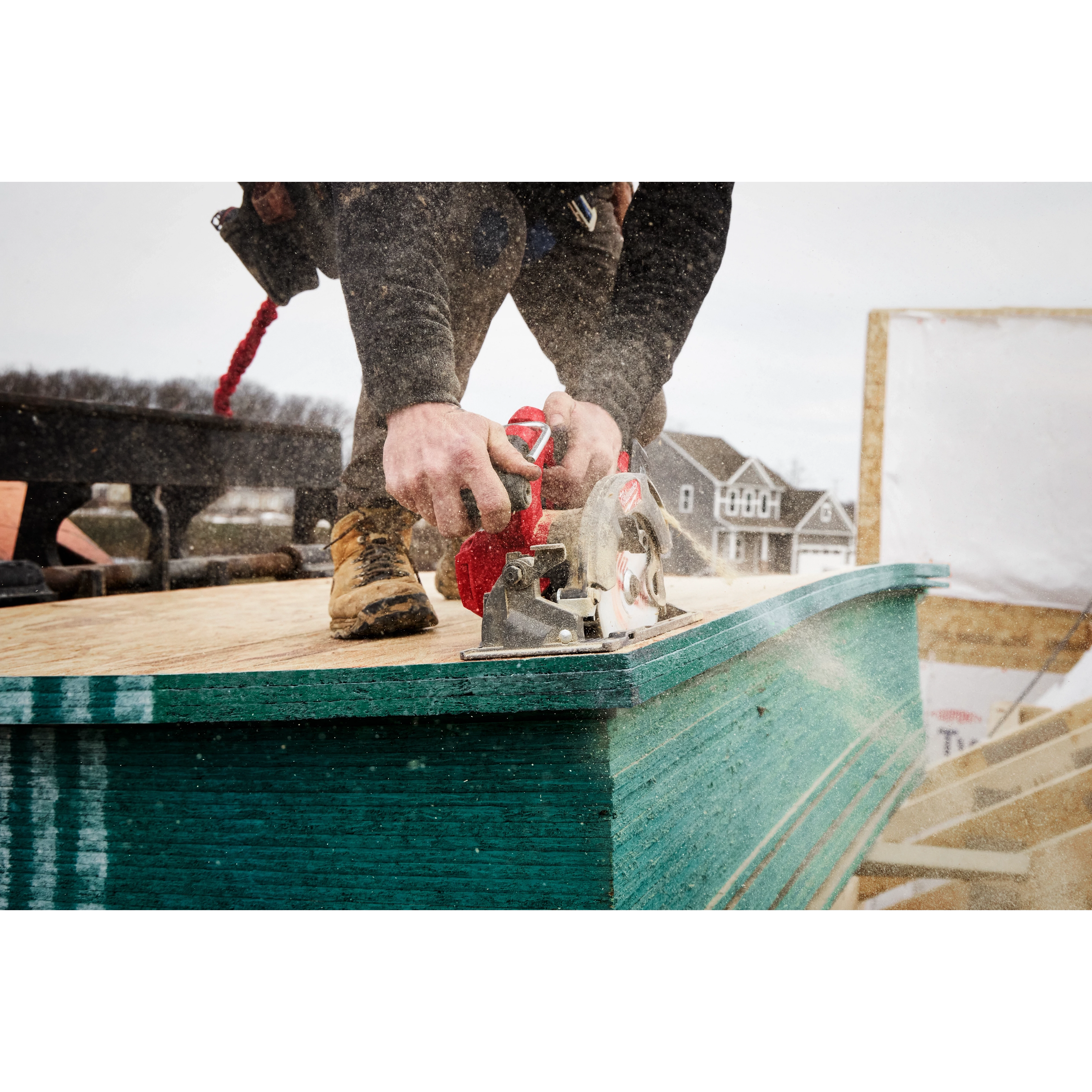 Image of a worker using the Milwaukee M18 FUEL 6-1/2" Circular Saw on a jobsite to cut wood
