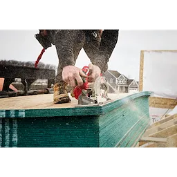 Image of a worker using the Milwaukee M18 FUEL 6-1/2" Circular Saw on a jobsite to cut wood