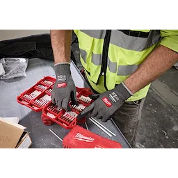 Worker wearing Cut Level 4 High Dexterity Nitrile Dipped Gloves w/ WEAR-DEFENSE Protection organizing drill bits.