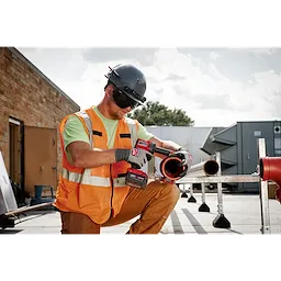 Worker wearing the BOLT Eye Visor Tinted Dual Coat Lens while drilling