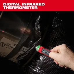 A person holds a digital infrared thermometer, displaying a reading of 70.8°F, against a metal surface wrapped in plastic. The thermometer is red-bodied with a digital screen and green detailing on the front. The packaging label is partially visible, revealing some product specifications.