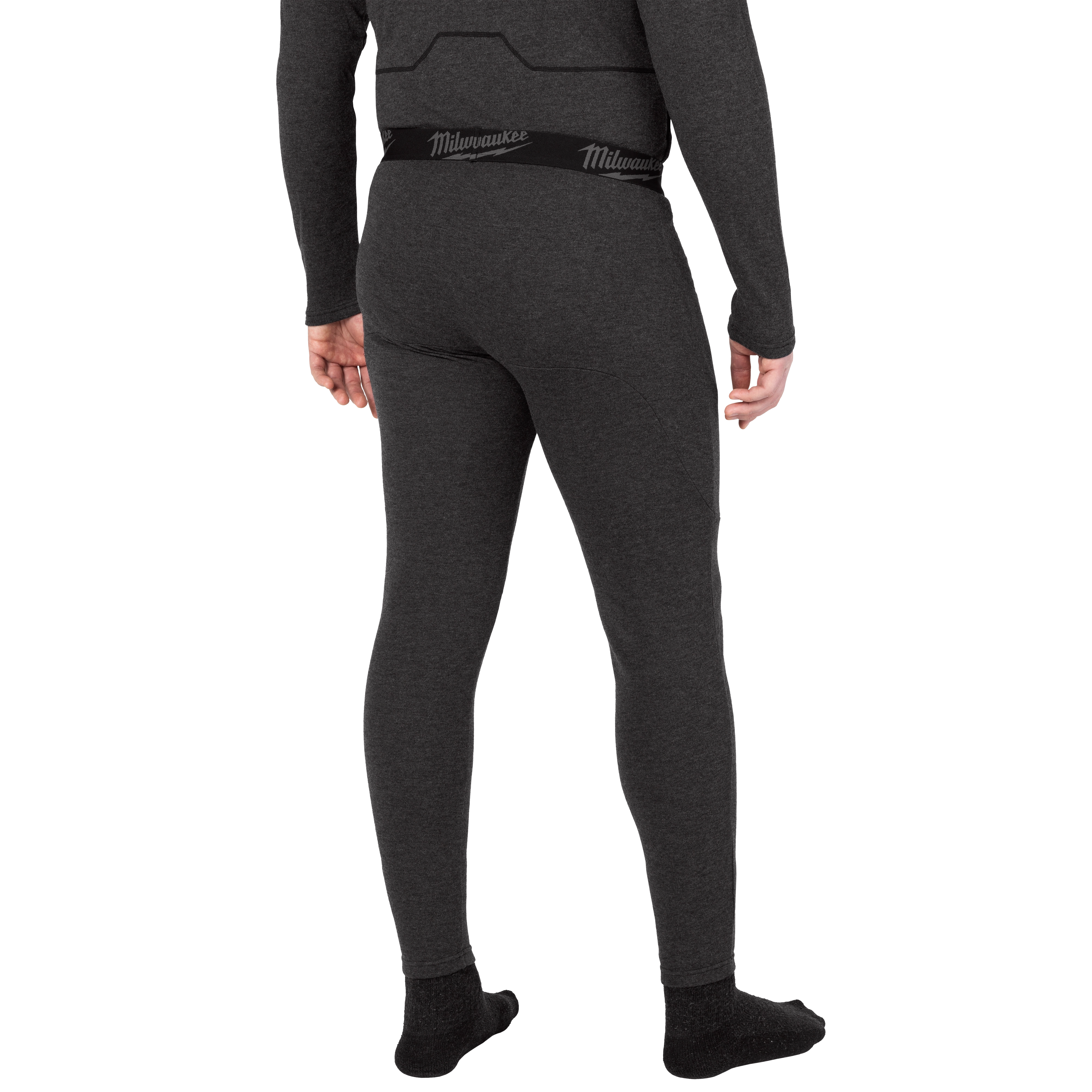 Milwaukee Heated Merino Wool Baselayer Pants in dark gray. A person wearing the pants is shown from the back, highlighting the fit and elastic waistband.