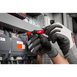 A technician uses the 14-in-1 Precision Multi-Bit Screwdriver to work on an electrical panel while wearing grey work gloves.