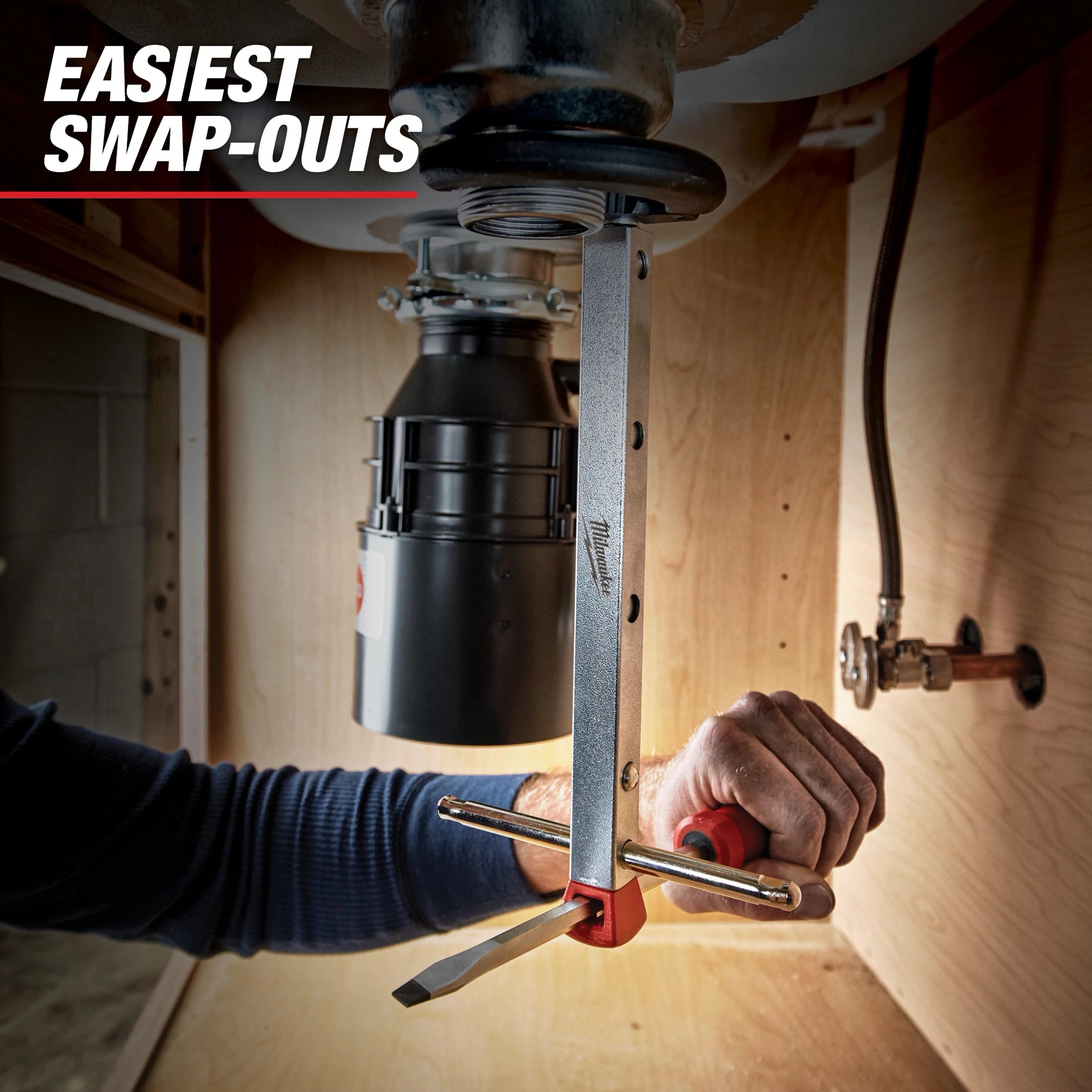 A Milwaukee Spanner Wrench is being used to install or remove a garbage disposal unit under a sink. The text "Easiest Swap-Outs" is displayed at the top left corner.