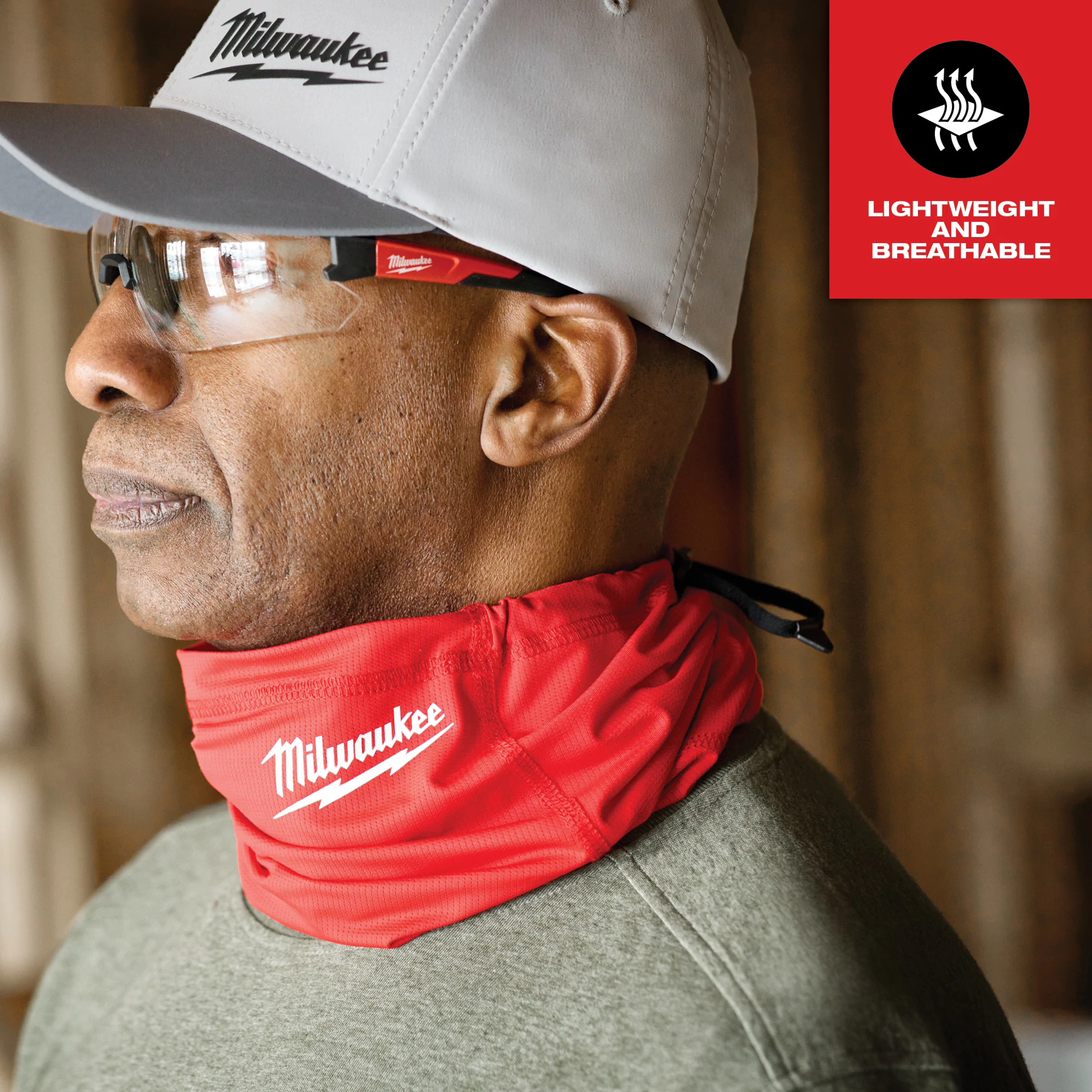 WORKSKIN Performance Neck Gaiter in red with a white logo worn around the neck. Features include lightweight and breathable material.