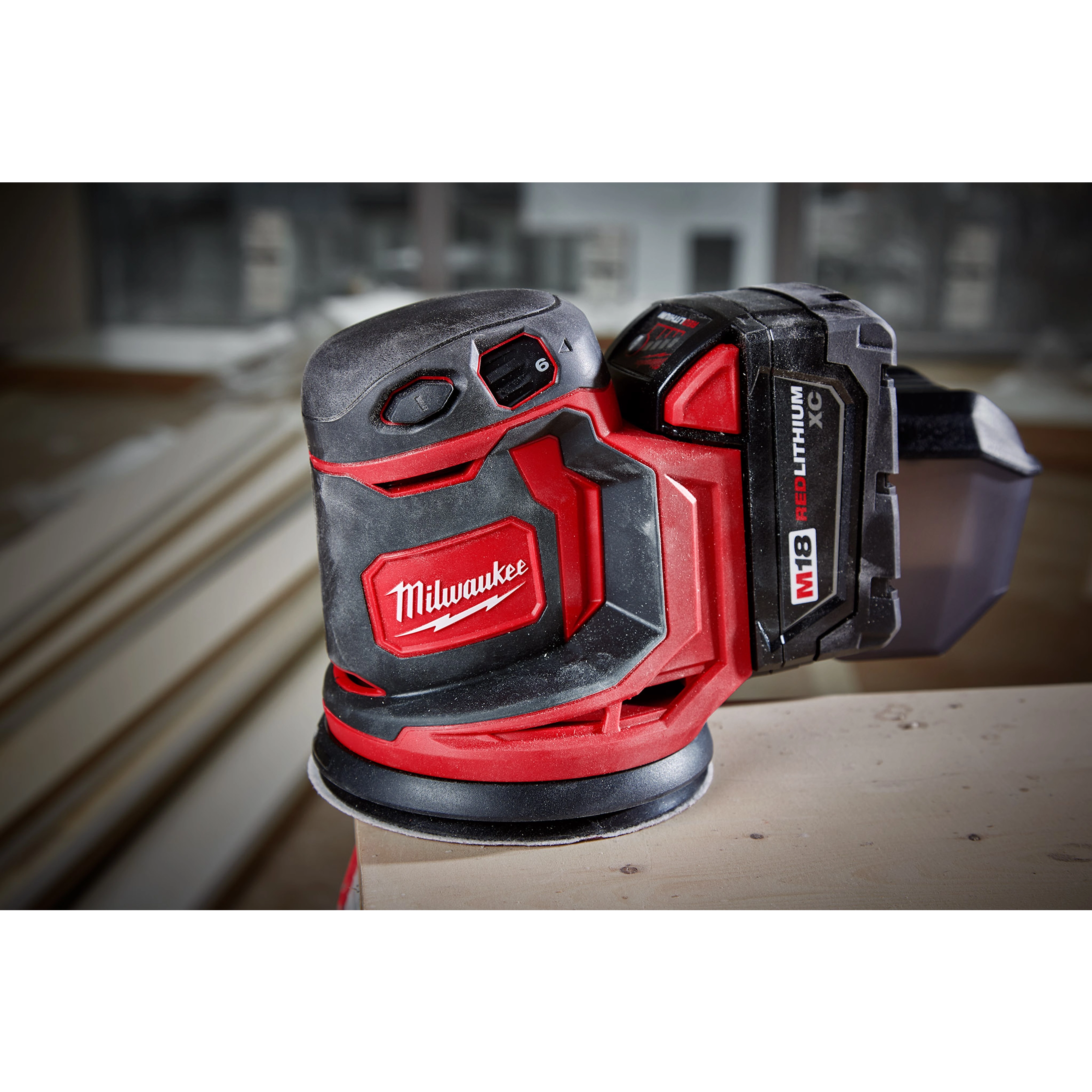 The M18 Random Orbit Sander is a red and black cordless power tool, designed for smoothing surfaces with a compact design.