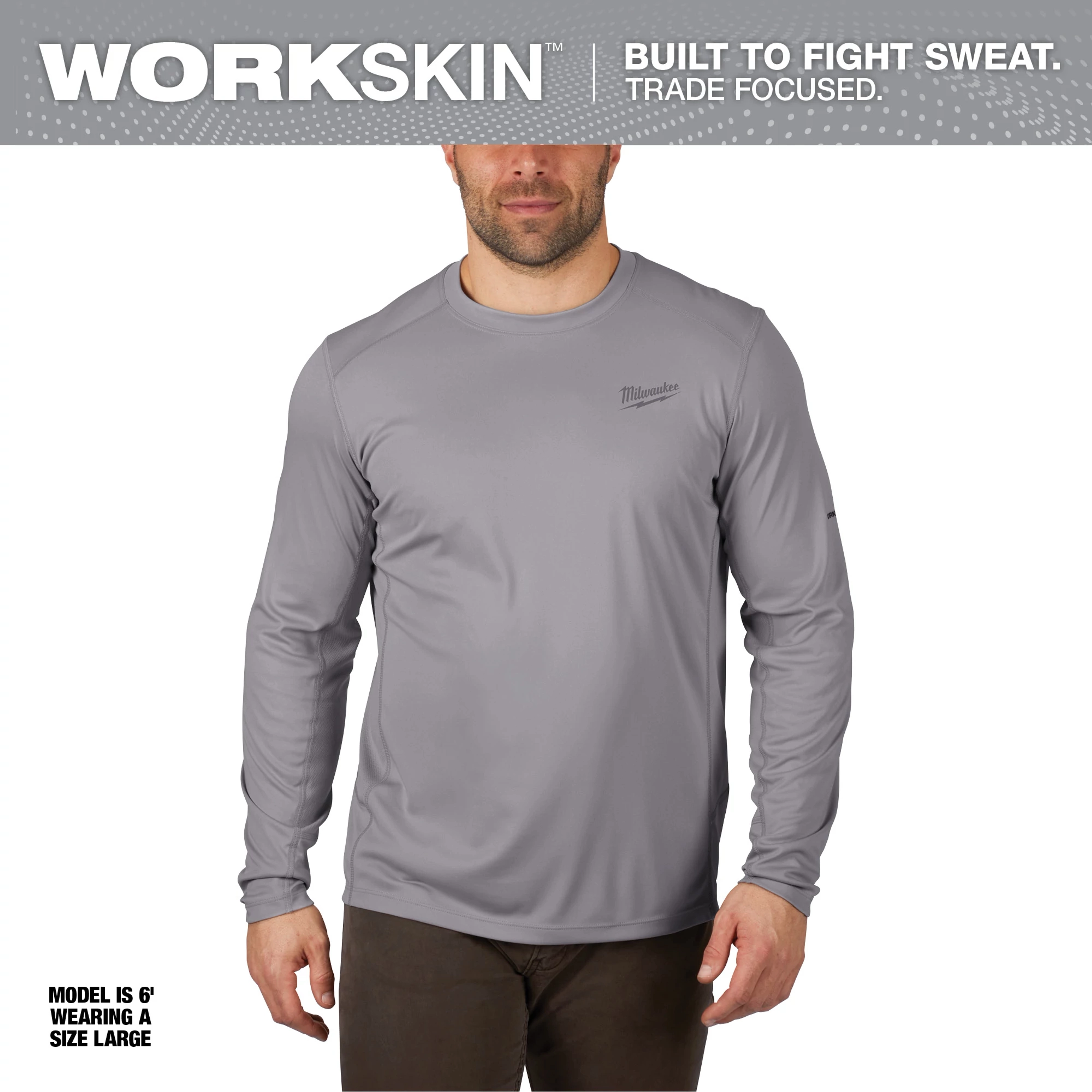 WORKSKIN Lightweight Performance Shirt - Long Sleeve in gray, worn by a model standing, is designed for sweat resistance and comfort.