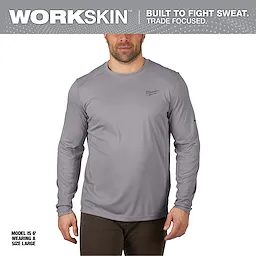 WORKSKIN Lightweight Performance Shirt - Long Sleeve in gray, worn by a model standing, is designed for sweat resistance and comfort.