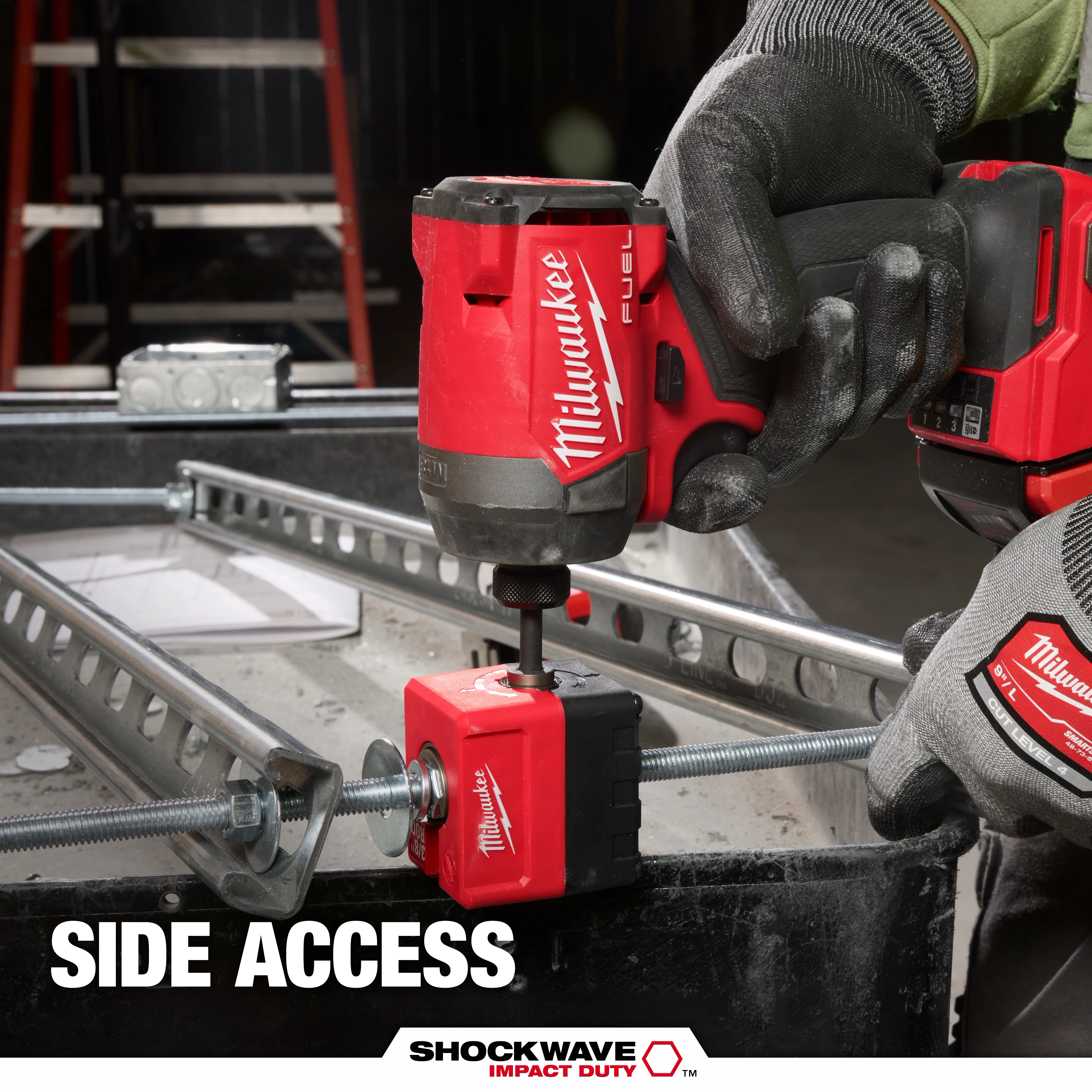 A Milwaukee drill is fastening a threaded rod nut using the SHOCKWAVE™ Impact Duty 3/8" Threaded Rod Nut Runner. A gloved hand holds the drill while the nut runner is attached to a metallic framework. The text on the image reads "Side Access." The equipment is in use at a construction site.
