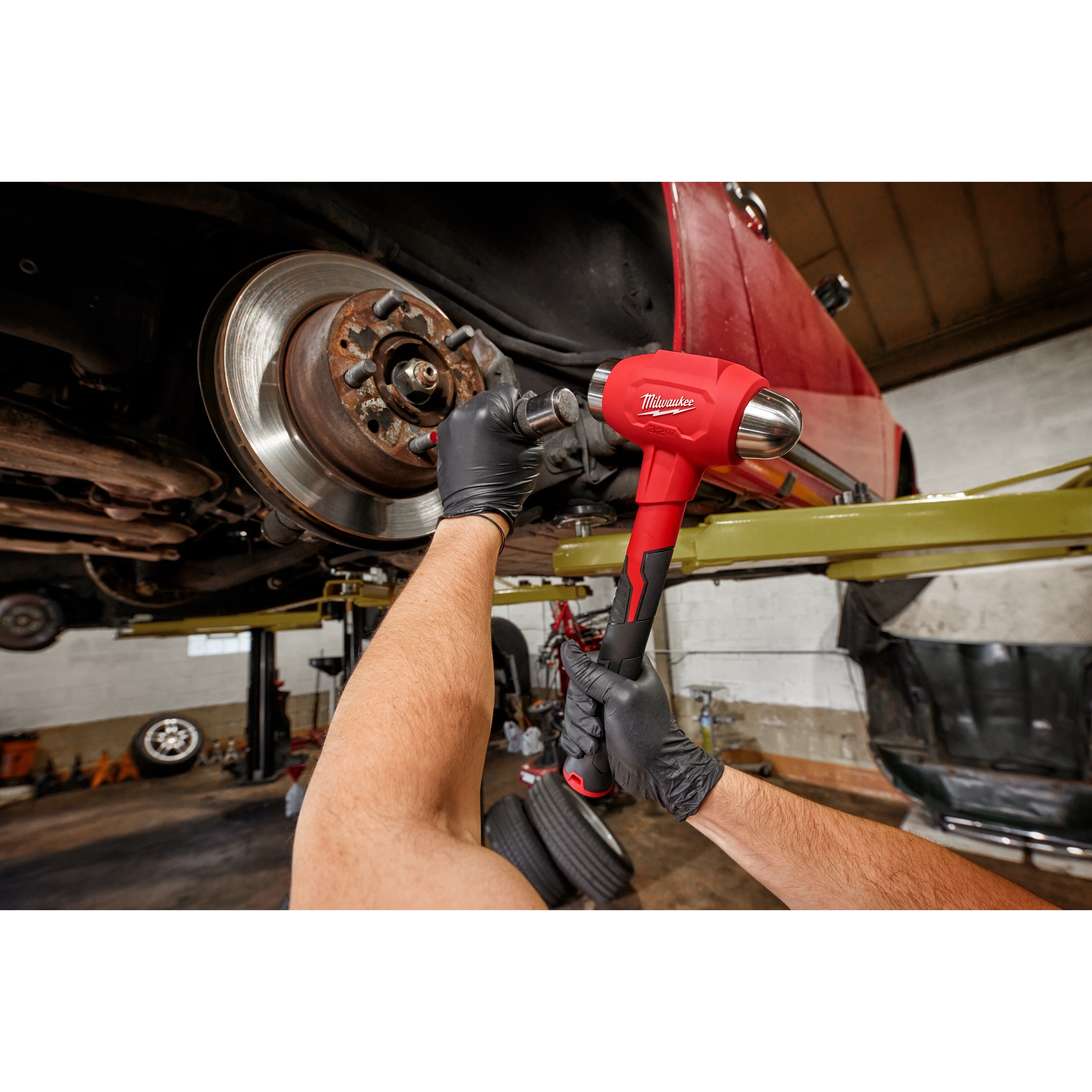 Worker using the 32oz Dead Blow Ball Peen Hammer for automotive use