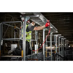 Worker using 10%20LB%20Extended%20Reach%20Locking%20Tool%20Lanyard for safety while operating a power tool at height on scaffolding.