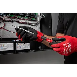 Person wearing red and black gloves using a 14-in-1 Precision Multi-Bit Screwdriver to work on an electrical panel.
