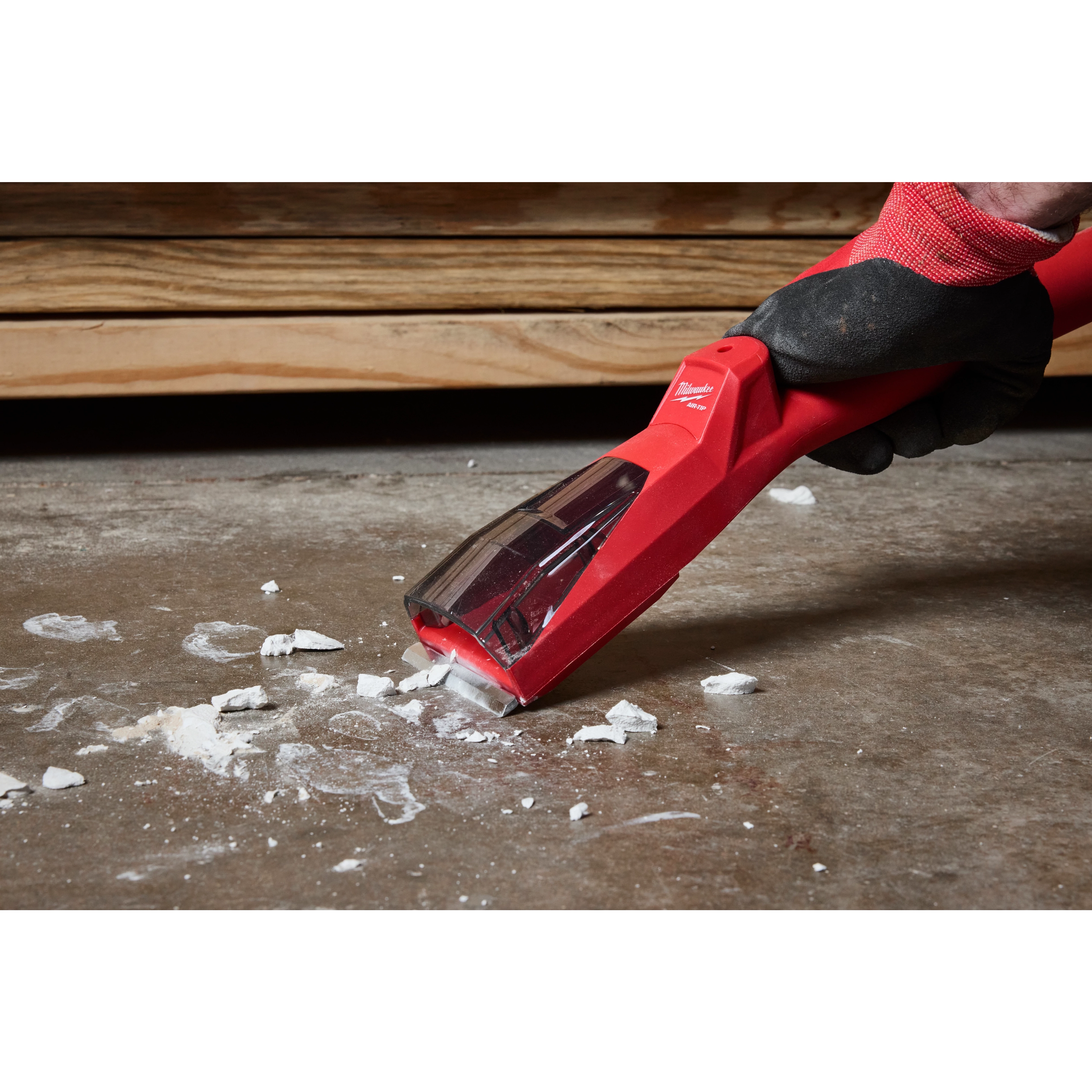 The AIR-TIP Debris Scraper is shown scraping debris off a concrete surface.