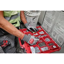Person wearing Cut Level 5 High Dexterity Polyurethane Dipped Gloves - L, sorting screws and tools in a red organizer box.