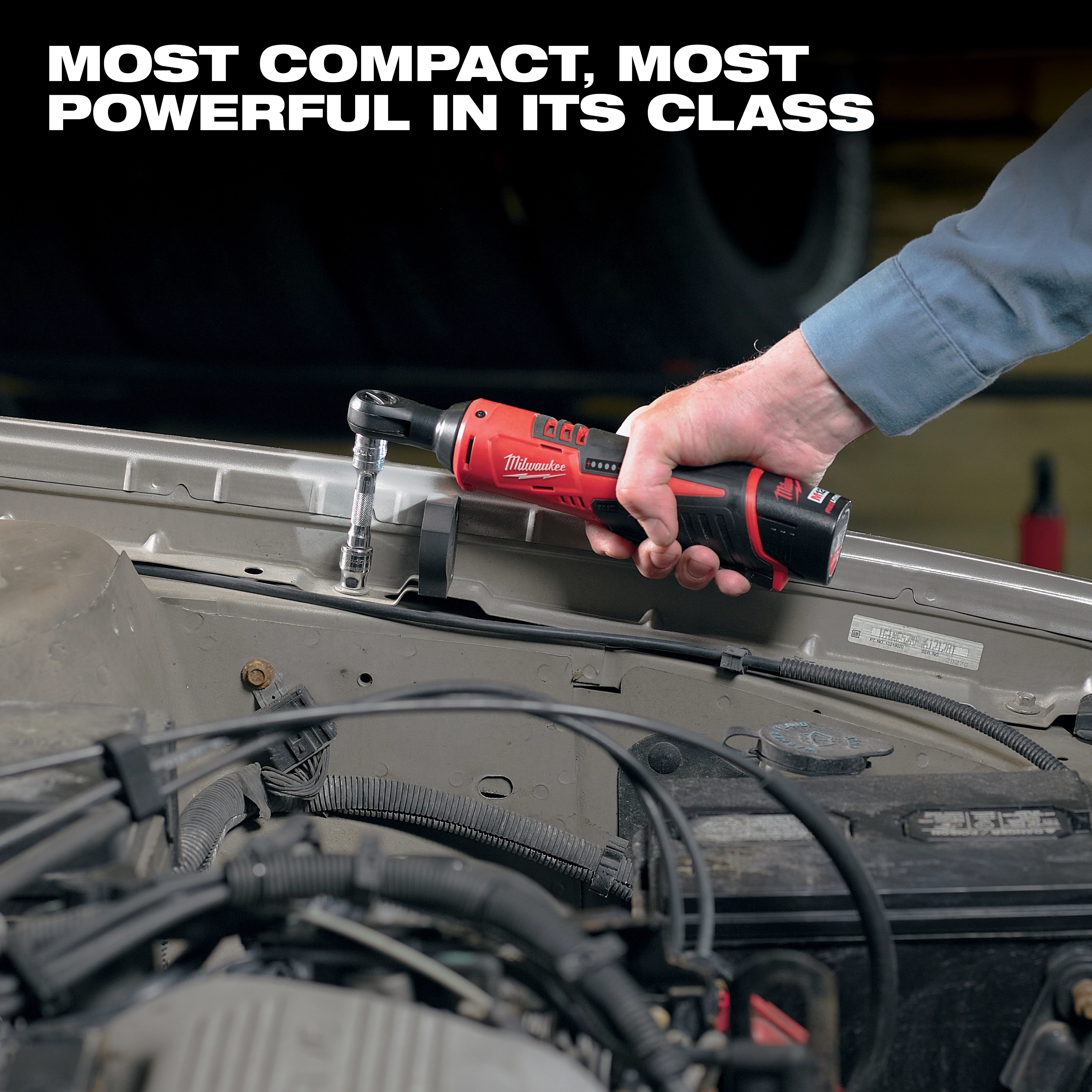 A person uses an M12 3/8" Ratchet to work on a vehicle engine. Text above the person reads "Most compact, most powerful in its class."
