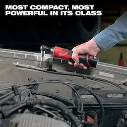 A person uses an M12 3/8" Ratchet to work on a vehicle engine. Text above the person reads "Most compact, most powerful in its class."