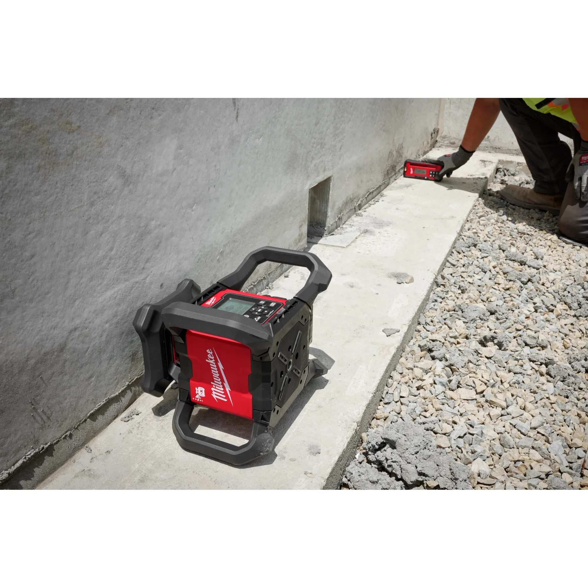 Worker using the Red Exterior Dual Slope Rotary Laser Receiver on concrete