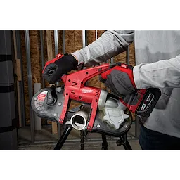 A person using the Compact Extreme Thin Band Saw Blade to cut a metal pipe, with a red and black handheld power tool.