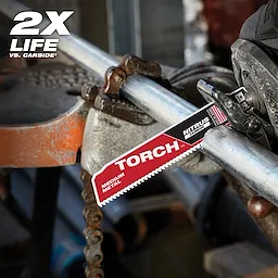 The Nitrus Carbide Life Claim blade is shown cutting through a metal pipe in a workshop setting. The words "2X Life" are displayed in the top-left corner, highlighting the product's durability. The red and black blade is labeled "Torch" and "Medium Metal."